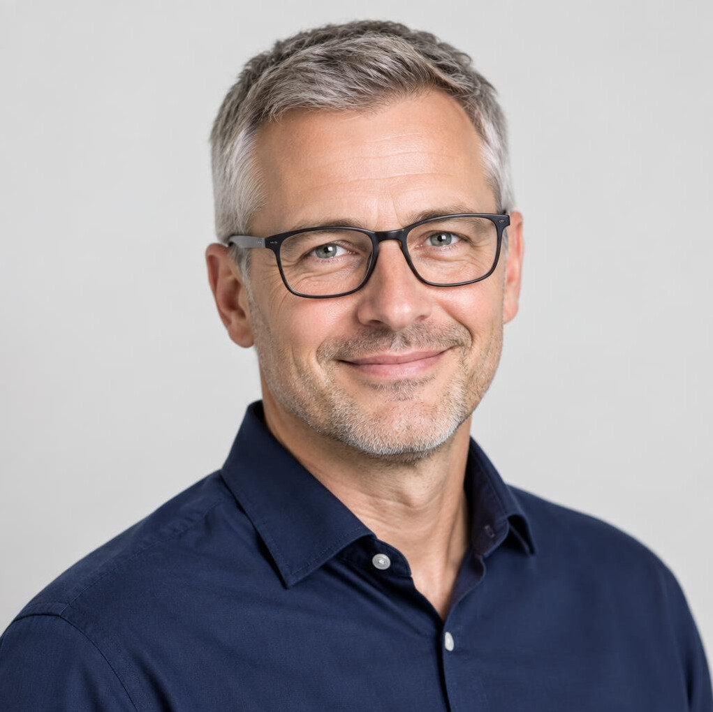 Studio portrait of a European man in his forties with glasses